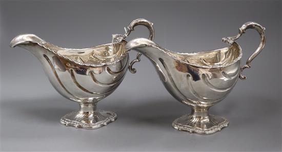 A pair of George III silver pedestal sauceboats, London, 1763?, (repairs), gross 27.5 oz.